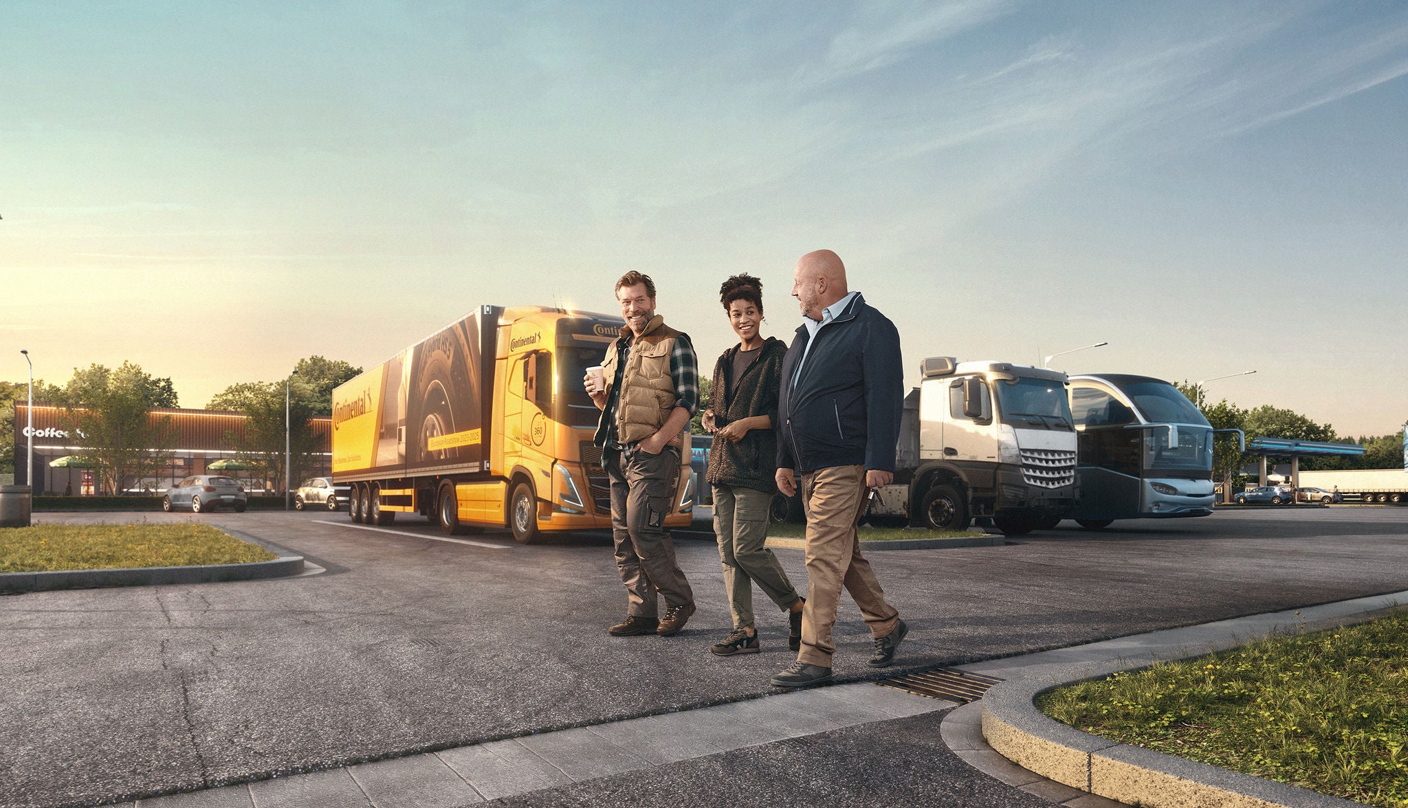 three people walking infront of orange/ black diesel Truck on a parking lot